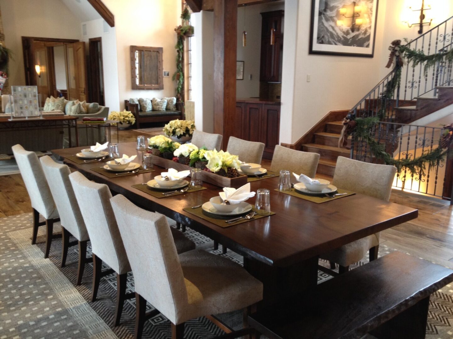 A large dining room table with chairs and plates.