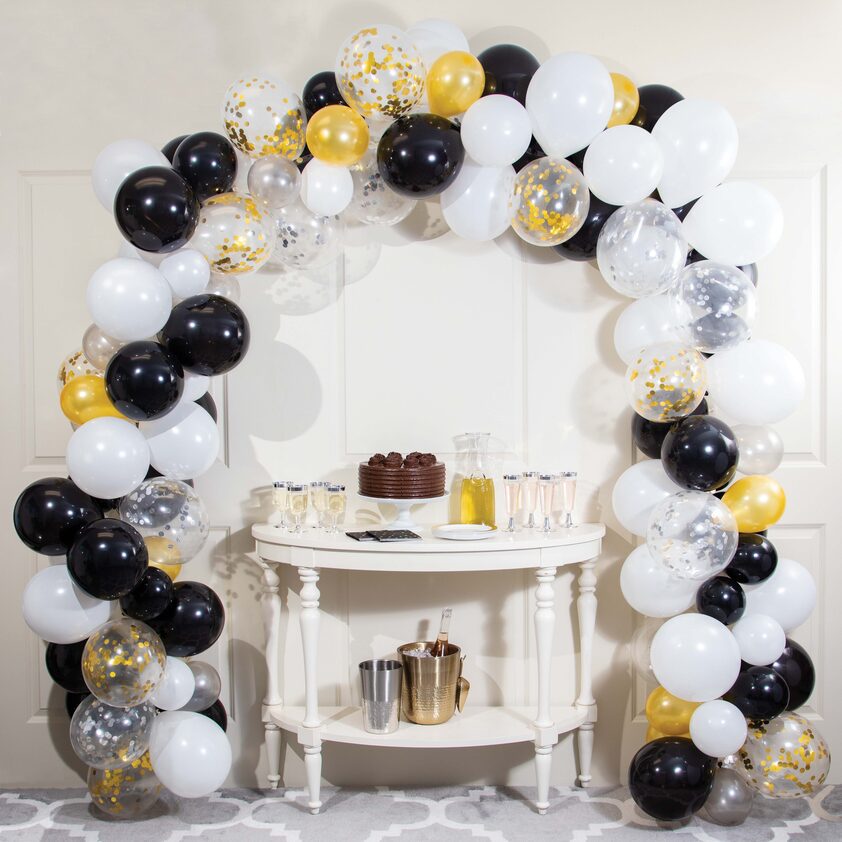 A table with cake and balloons on it