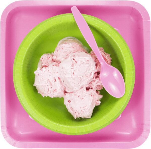 A green bowl filled with ice cream and a pink spoon.