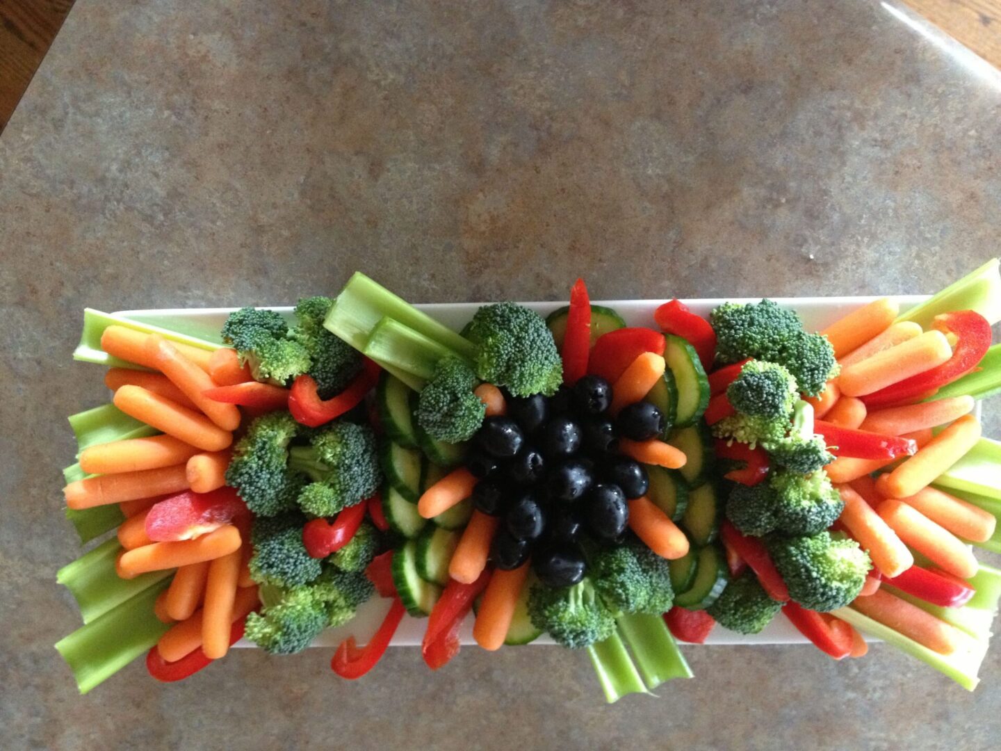 A tray of vegetables is shown on the table.