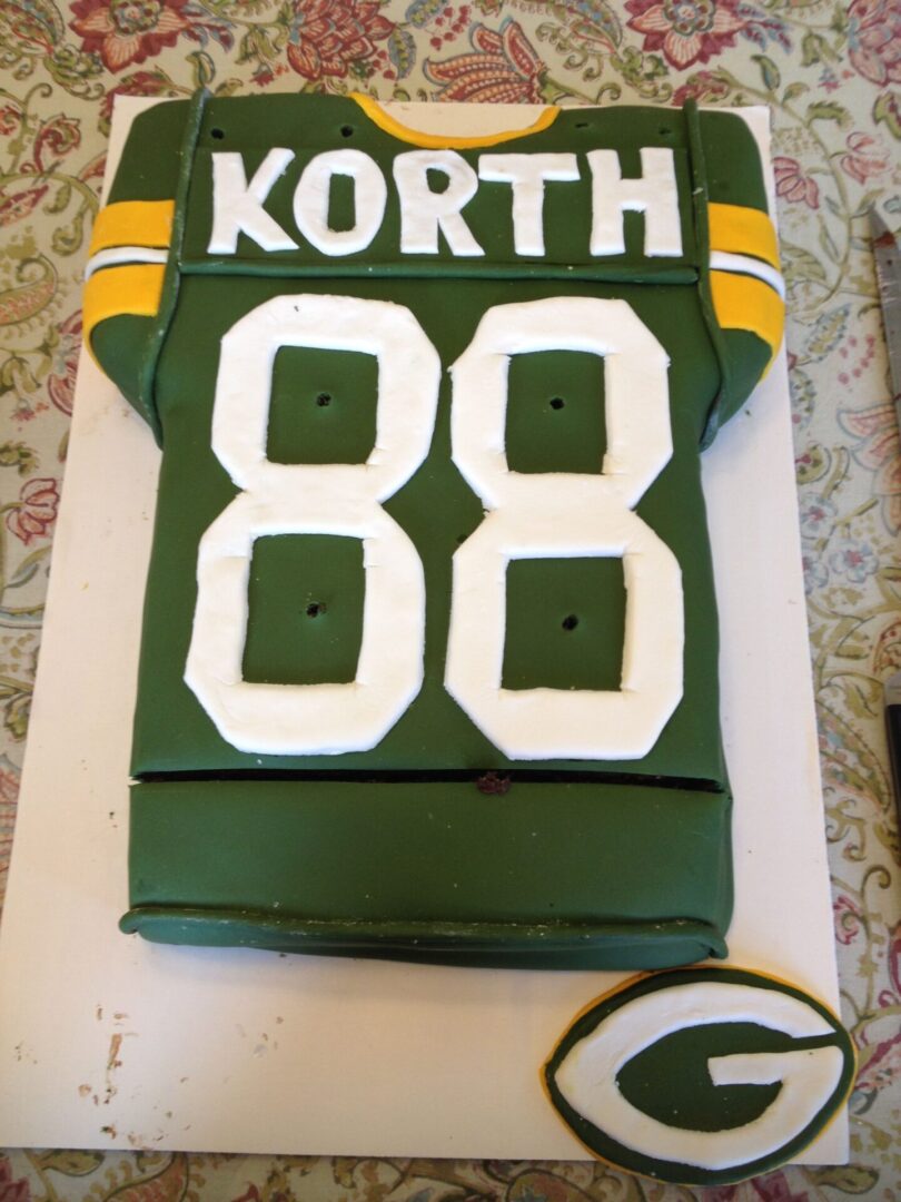 A cake that is shaped like the jersey of a football player.